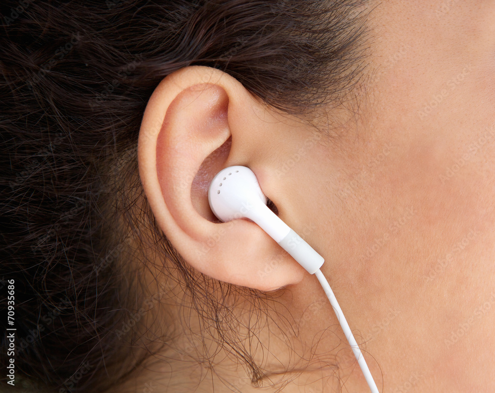 Fototapeta premium Young woman ear with earphone