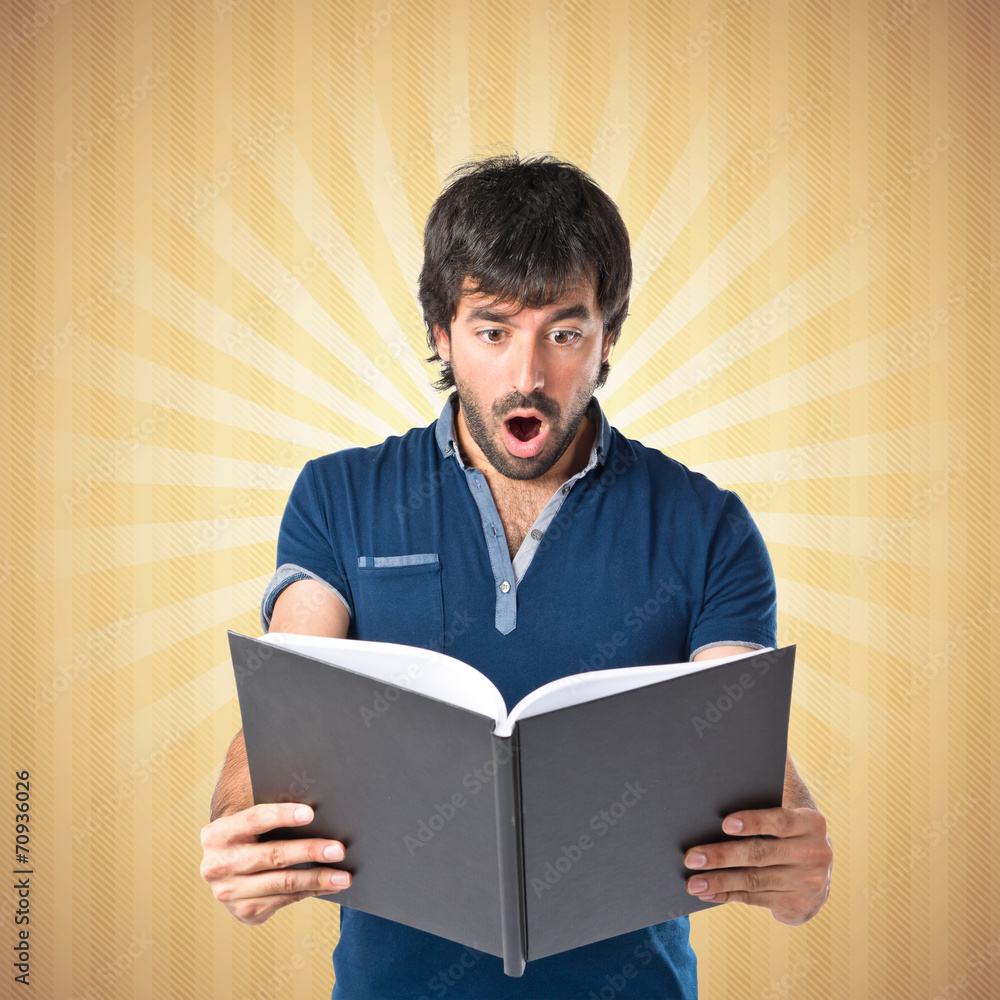 Man reading a book over pop background Man reading a book over pop background