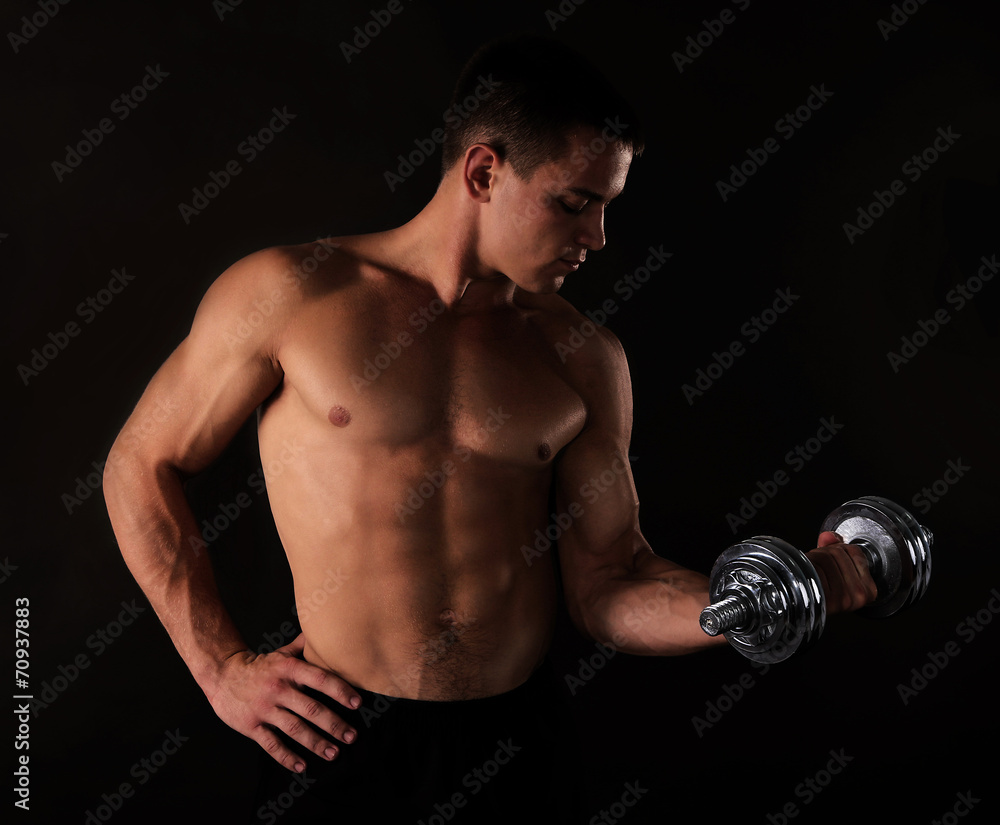 Athletic man execute exercise with dumbbells,