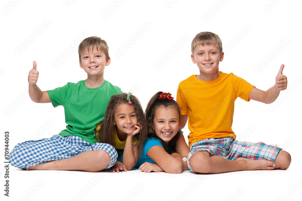 Laughing children hold their thumbs up Laughing children hold their thumbs up