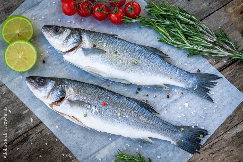 Two raw seabass with lime, cherry tomatoes and rosemary Two raw seabass with lime, cherry tomatoes and rosemary