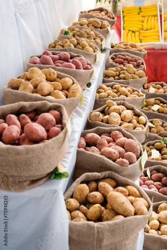 Harvest raw potatoes in burlap sack in market