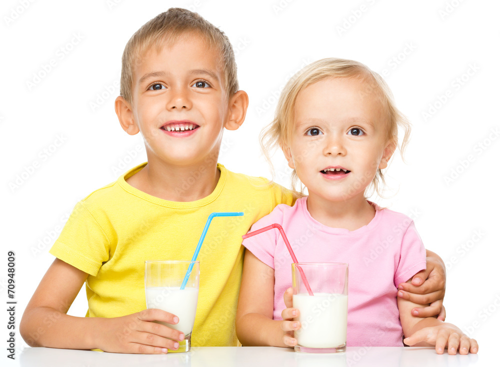 Cute little girl and boy are drinking milk Cute little girl and boy are drinking milk