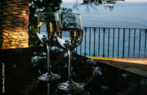 Glasses, water and pines photo