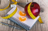 Measuring tape wrapped around a apple weight loss photo