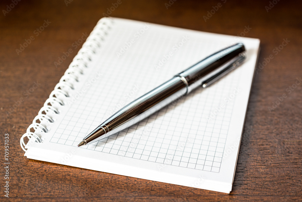 Notebook with a pen on the table Notebook with a pen on the table
