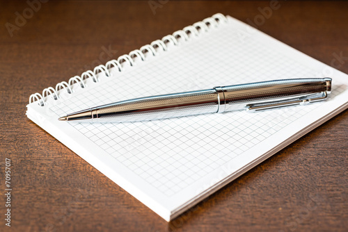 Notebook with a pen on the table