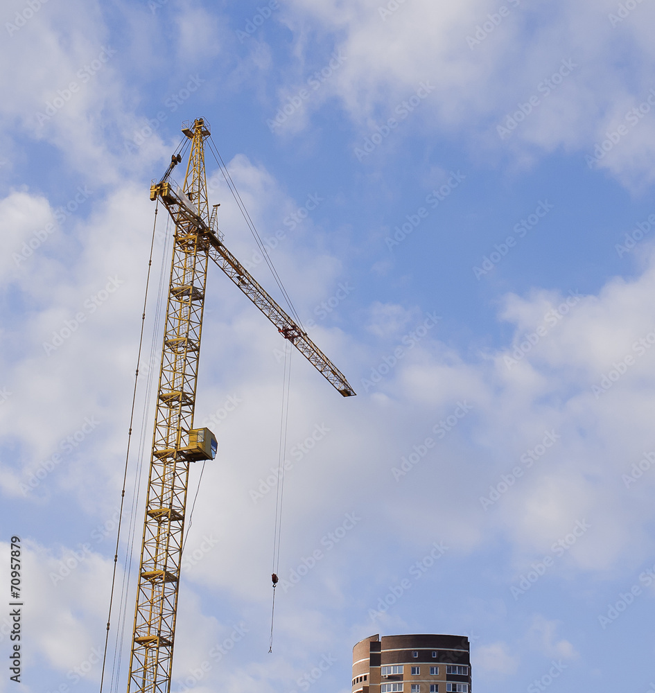 construction crane against a background of blue sky construction crane against a background of blue sky