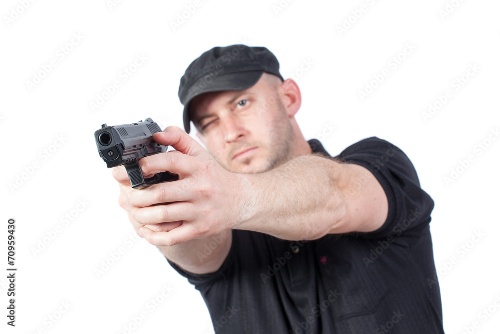Man pointing gun, isolated on white. Focus on the gun Man pointing gun, isolated on white. Focus on the gun