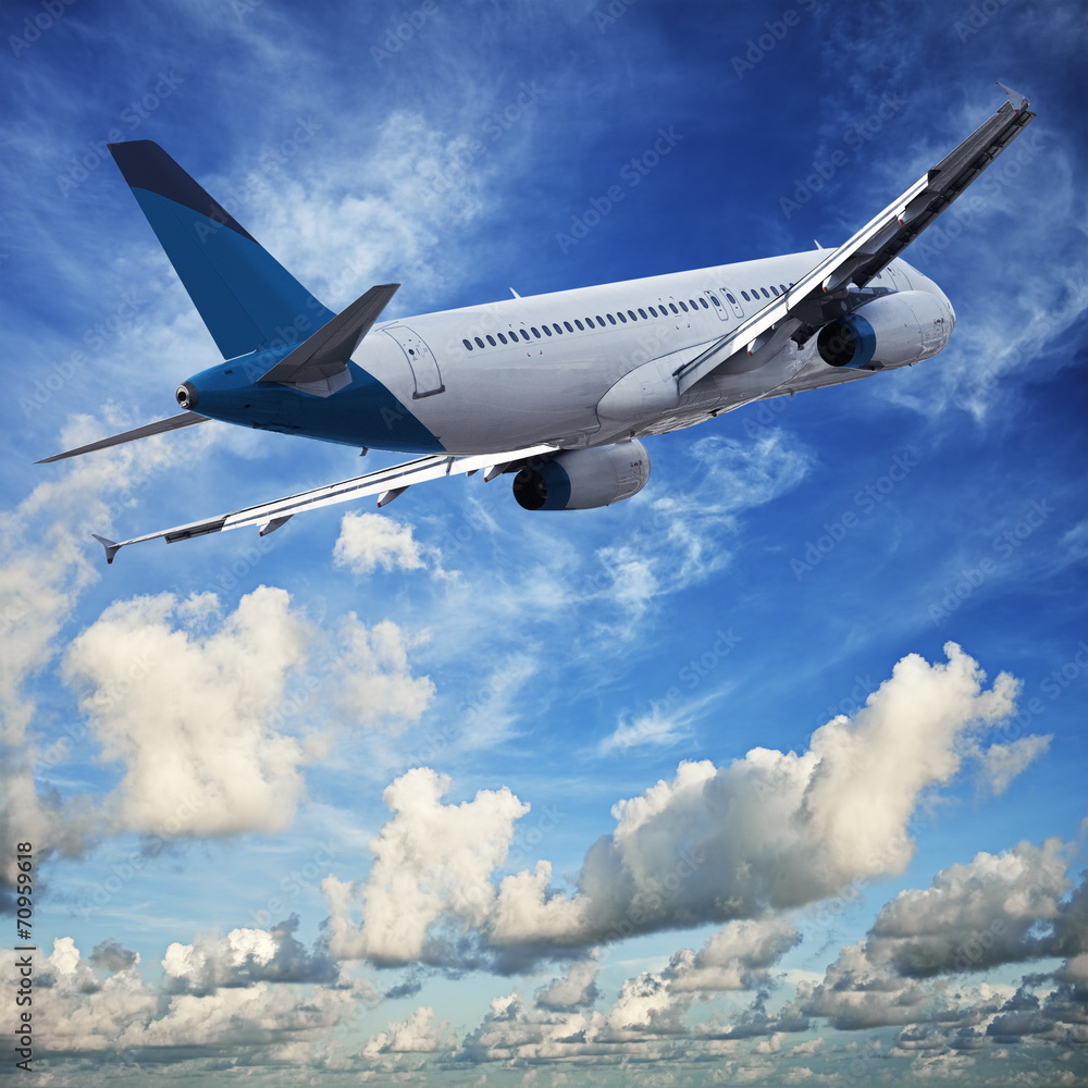 Jet cruising in a blue cloudy sky Jet cruising in a blue cloudy sky