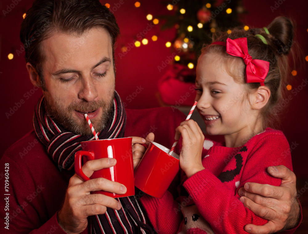 Christmas - father and daughter drink cocoa and having fun Christmas - father and daughter drink cocoa and having fun
