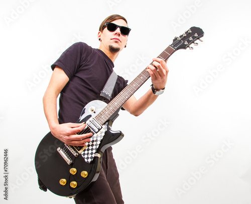 young rockstar playing on guitar
