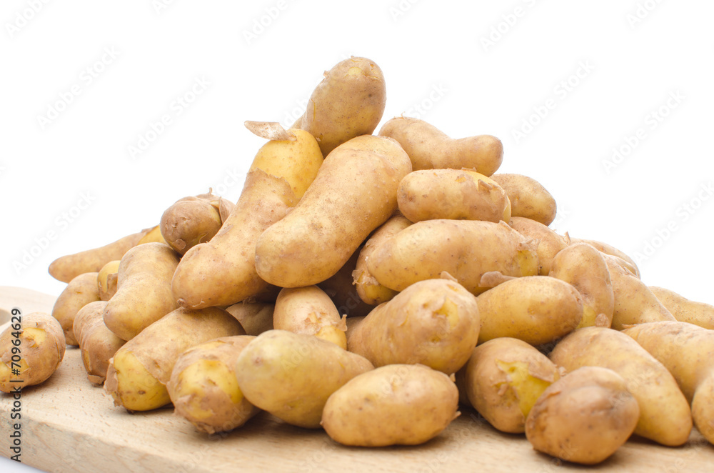 New rattes potatoes on a wooden board New rattes potatoes on a wooden board