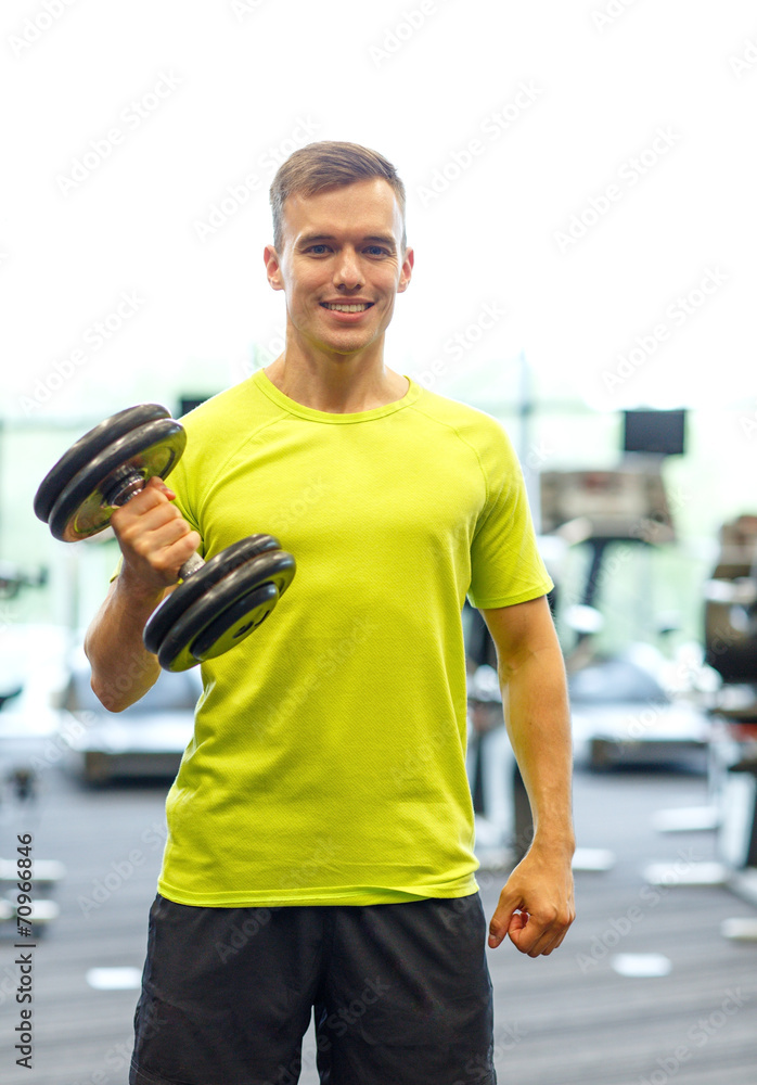 smiling man with dumbbell in gym smiling man with dumbbell in gym