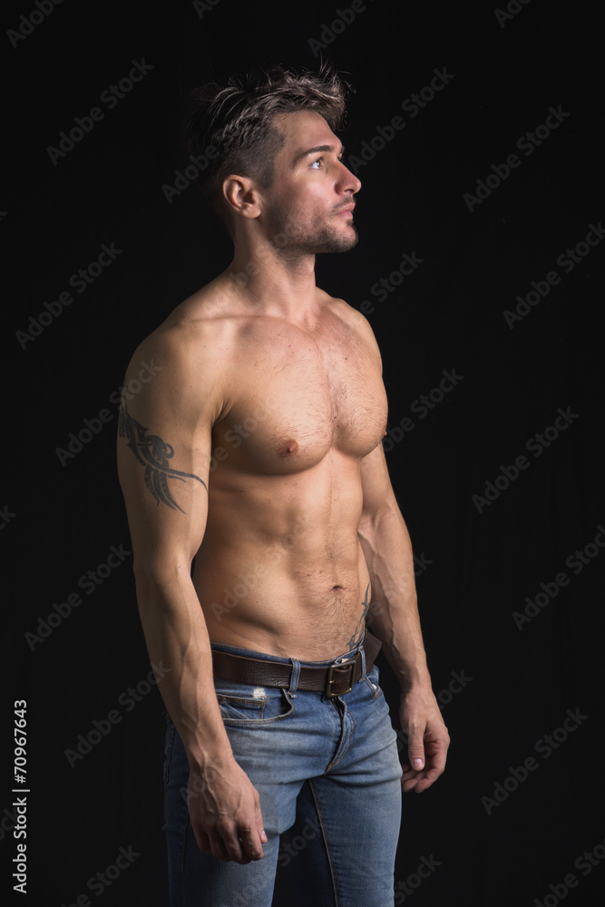 Fototapeta premium Handsome shirtless muscular man on black