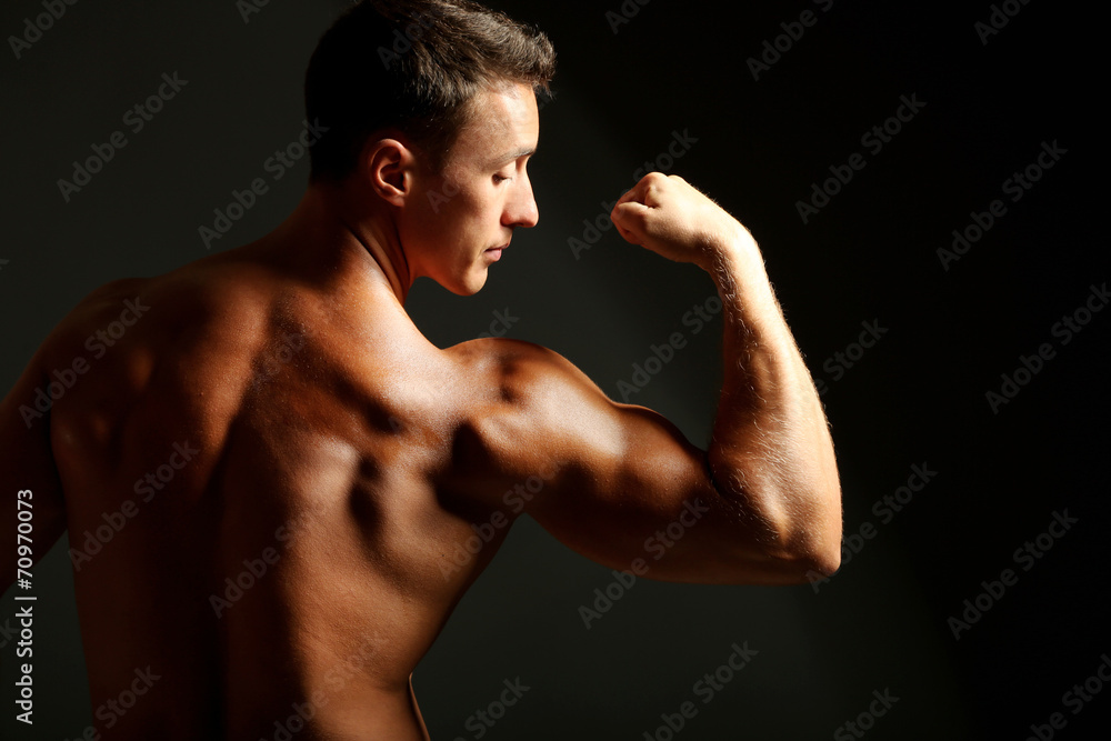 Handsome muscle young man on dark background Handsome muscle young man on dark background