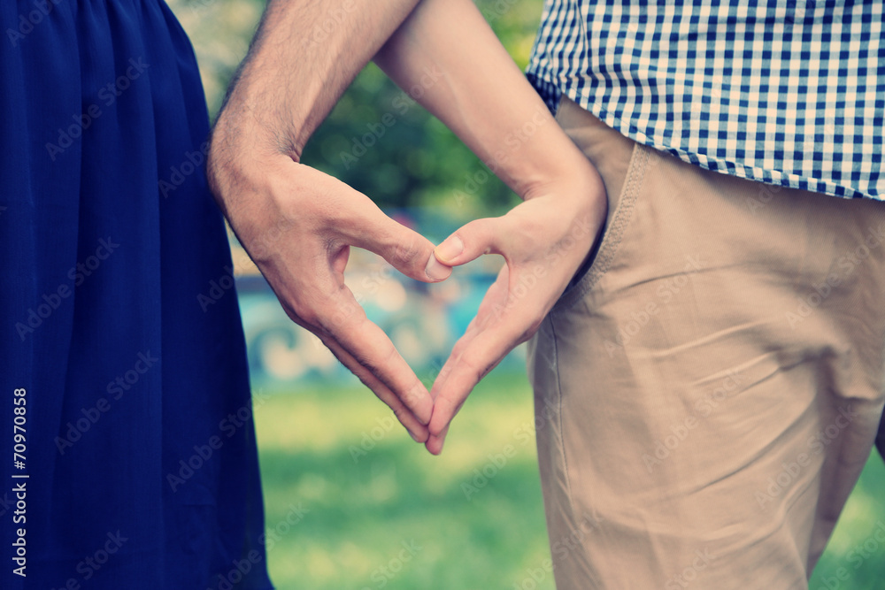 Young couple in love make heart Young couple in love make heart