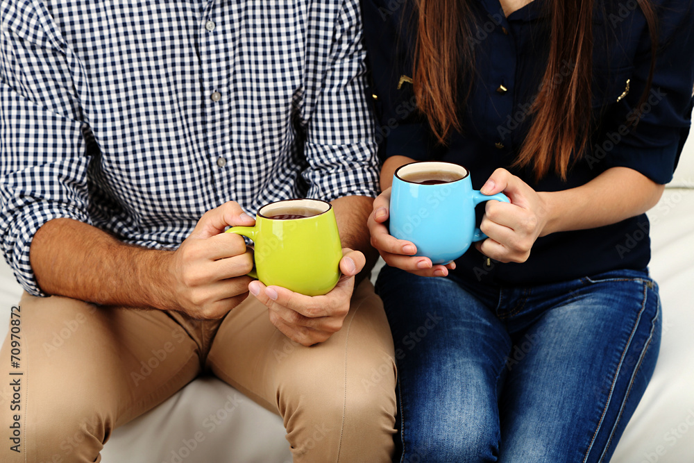 Young couple drinking tea, close-up Young couple drinking tea, close-up