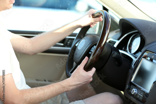 Man's hands on a steering wheel © Africa Studio