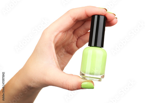 Nail polish in hand, isolated on white