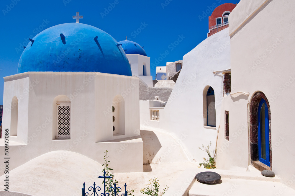 Oia Orthodox churches domes on Santorini island, Greece.