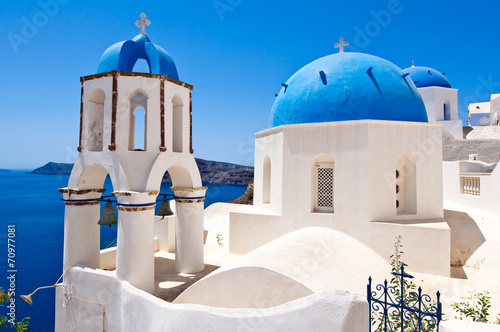 Oia Orthodox churches domes and the bell-tower. Santorini.