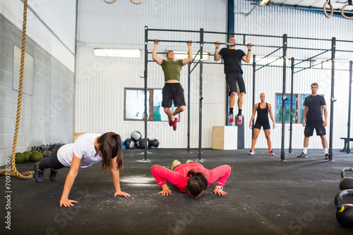 Athletes Exercising In Gym