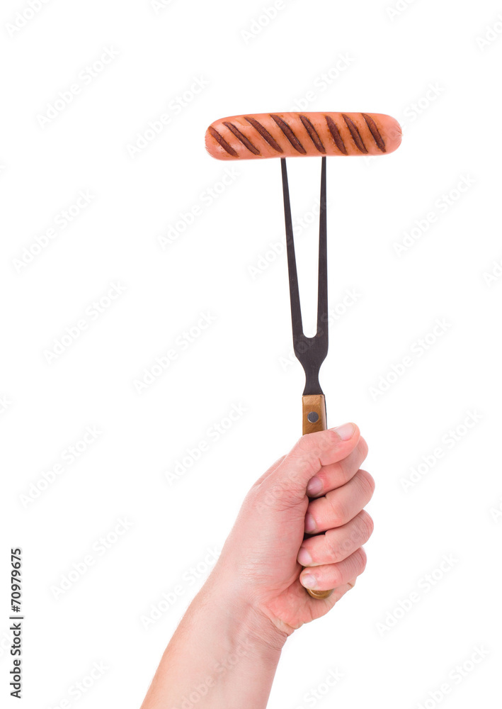 Grilled sausage on a fork. Grilled sausage on a fork.