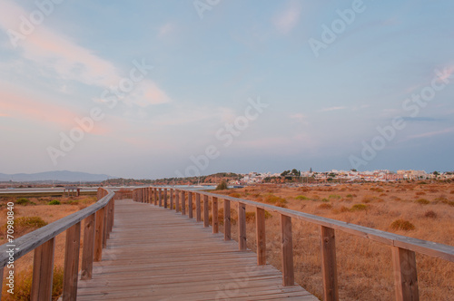 Wooden footbridge in the dunes  Algarve  Portugal  at sunset