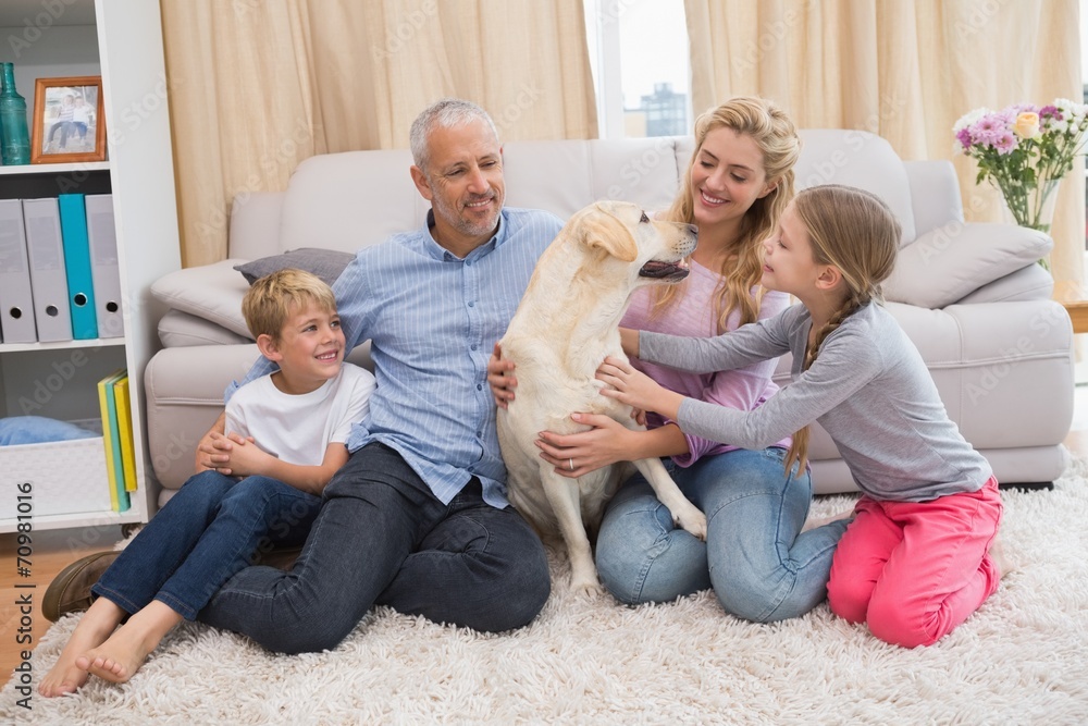 Parents and children on rug with labrador Parents and children on rug with labrador