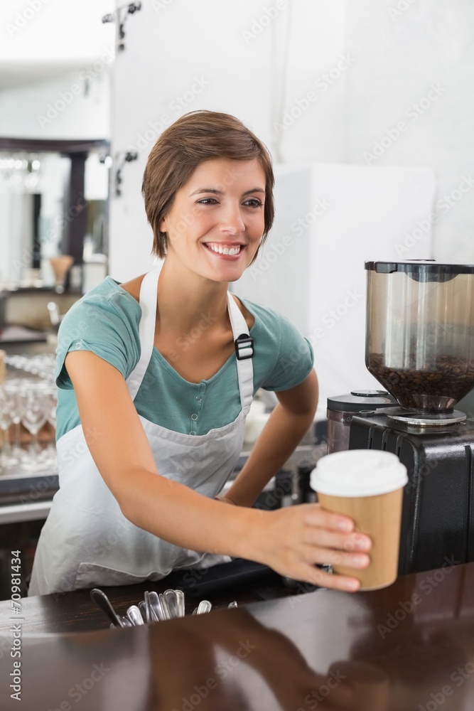 Pretty barista holding disposable cup Pretty barista holding disposable cup