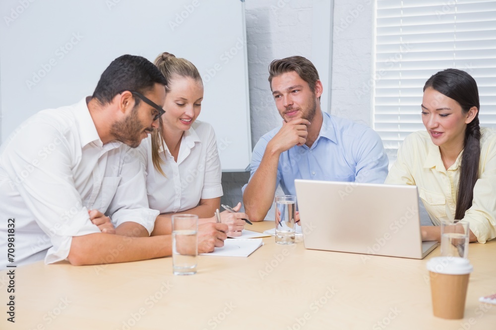Casual business team having a meeting using laptop Casual business team having a meeting using laptop