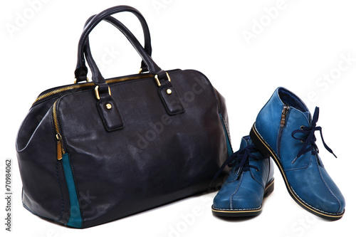 Modern women's fashion footwear and bag against white background