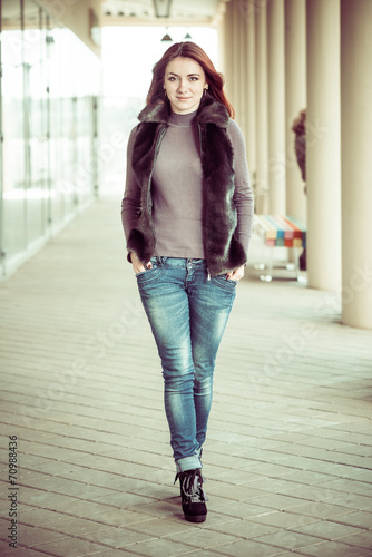 pretty redhead woman walking at downtown street