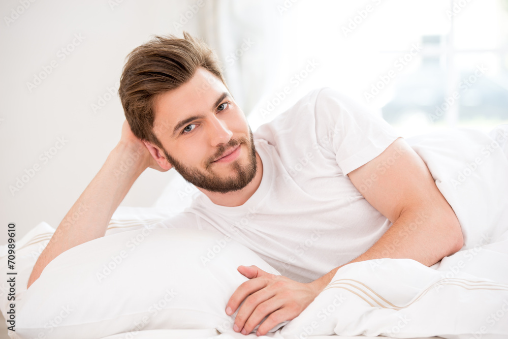 Handsome young man in white bed Handsome young man in white bed