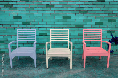 color wooden chair with brick wall background