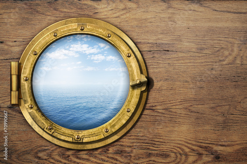 ship or boat porthole on wooden wall photo