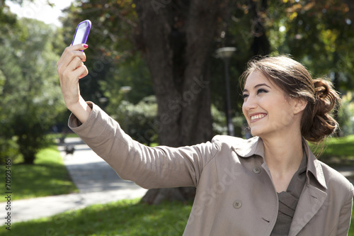 Woman photographing with mobile phone