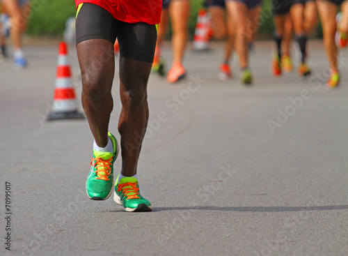 athlete runs down the street during the race outdoors