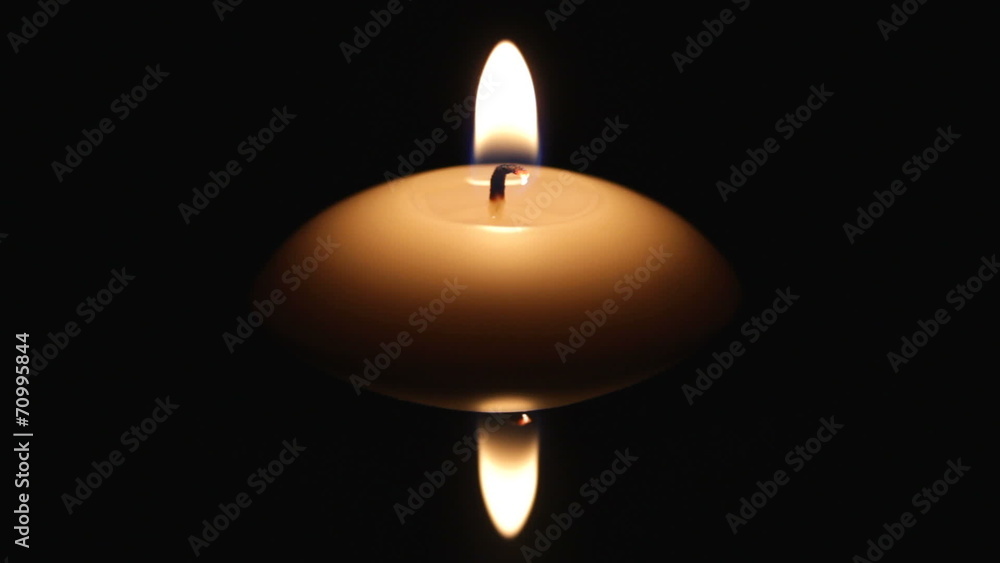 candle on dark water surface candle on dark water surface
