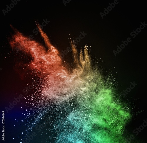 Colourful powder exploding isolated on black © Nejron Photo