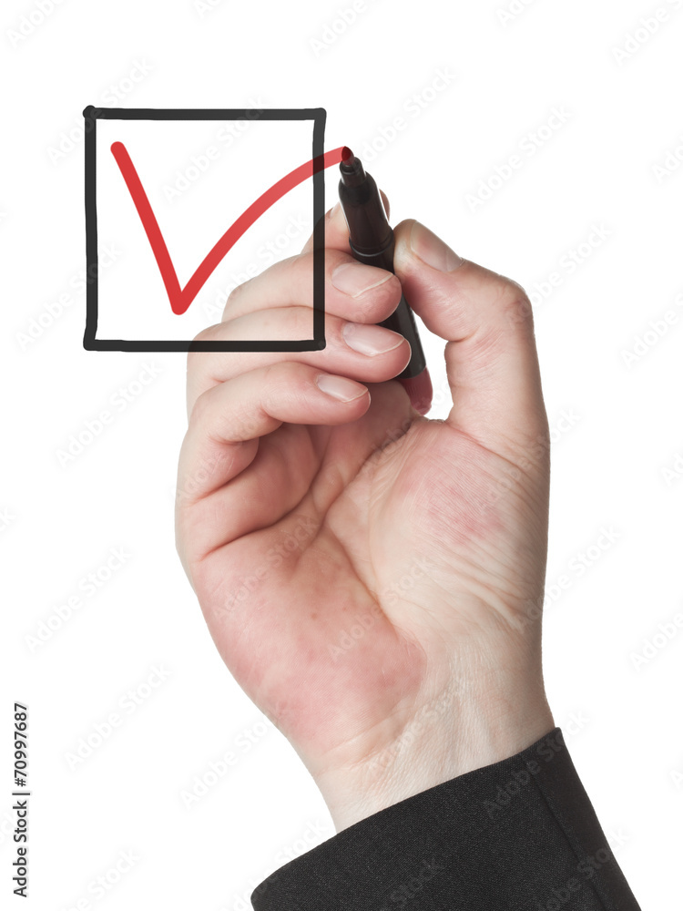 Male hand checking checkbox with red marker Male hand checking checkbox with red marker