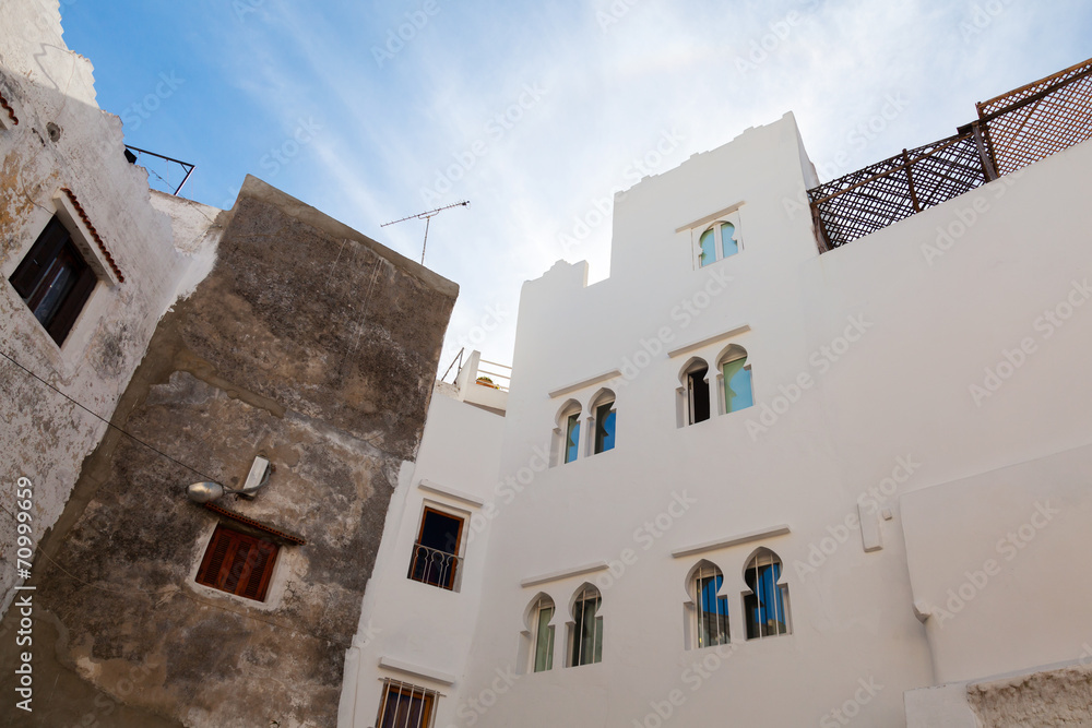 Walls, small windows and blue sky. Medina, old part of Tangier,