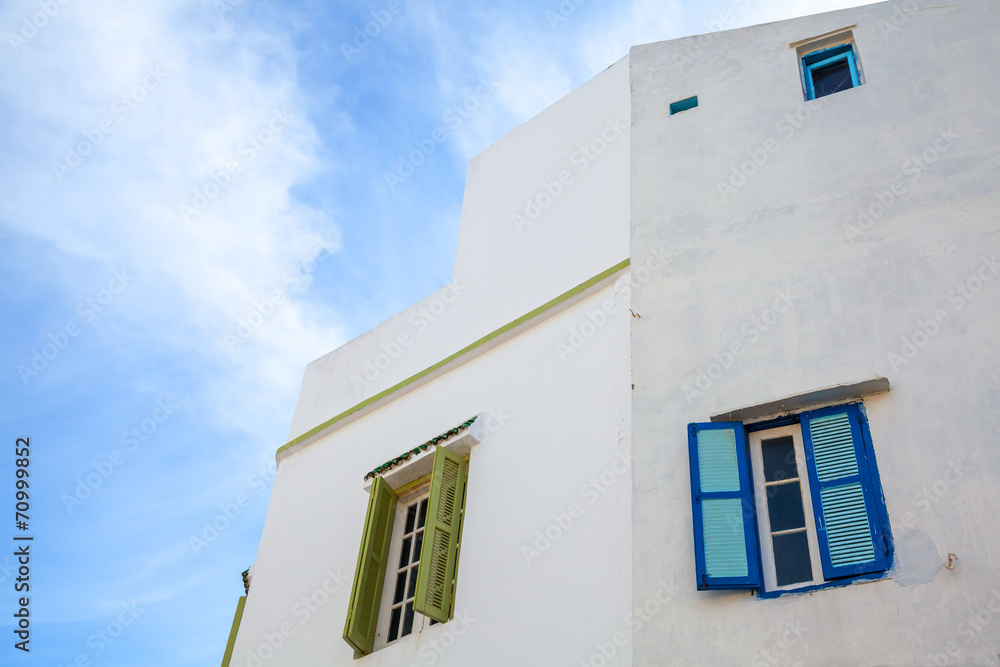 White wall with windows and blue sky. Medina, old part of Tangie