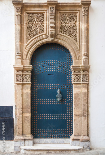 Ancient blue door with decoration. Tangier, Morocco © evannovostro