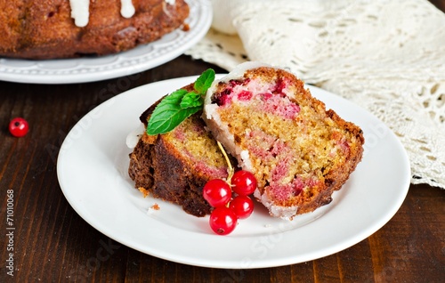 Marble berry cake with red currant on wooden backgraund. Slice of cake. Selective focus