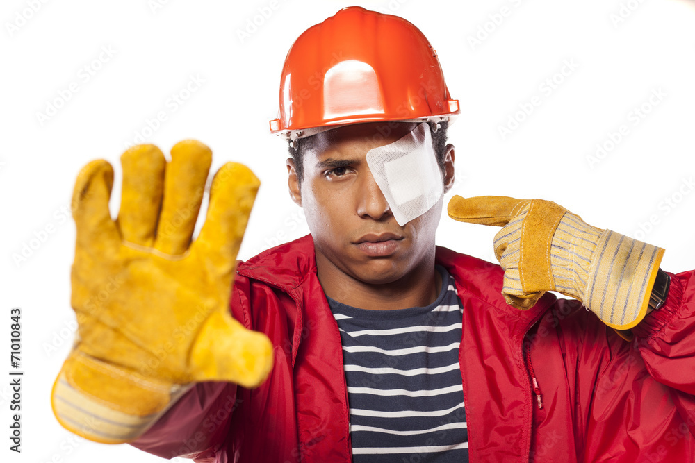 sad african worker with helmet and injured eye showing stop hand sad african worker with helmet and injured eye showing stop hand