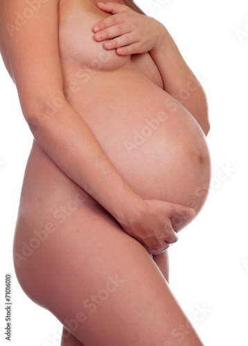Delicate pose of a pregnant woman with naked torso