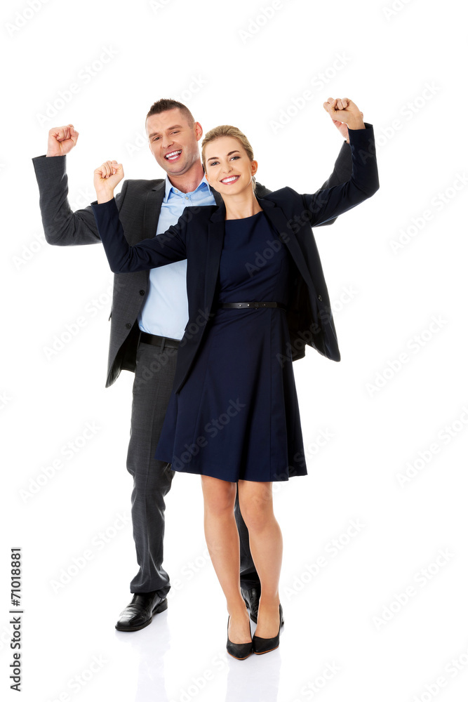 Victorious business couple with hands up Victorious business couple with hands up