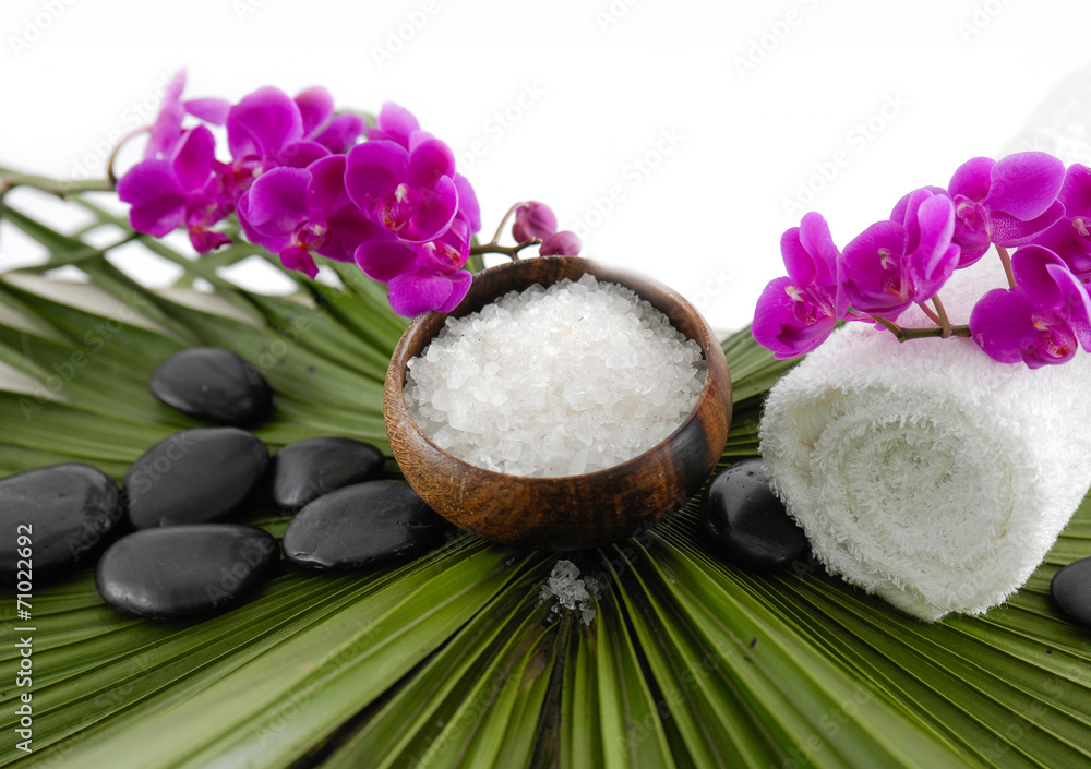 orchid and roller white towel on ,stones on green palm orchid and roller white towel on ,stones on green palm